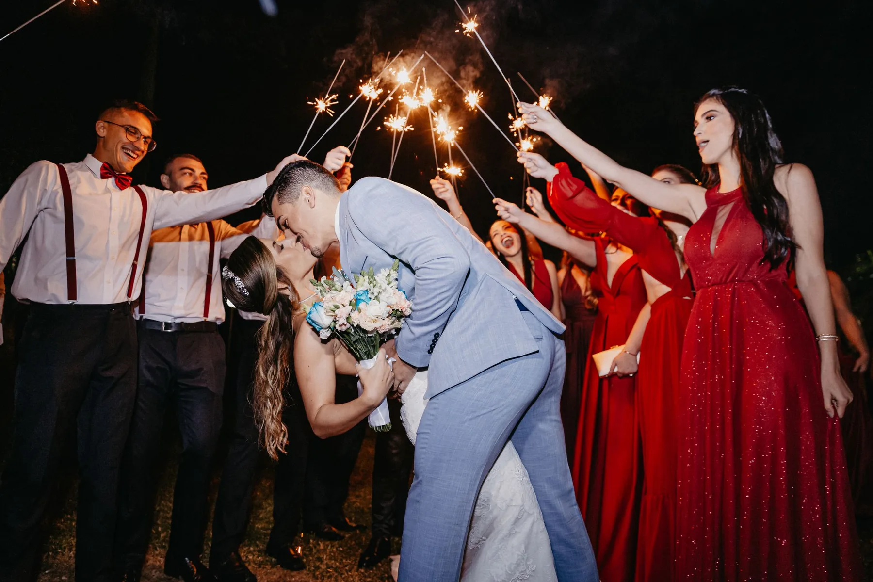 Guests lining an aisle covered in petals