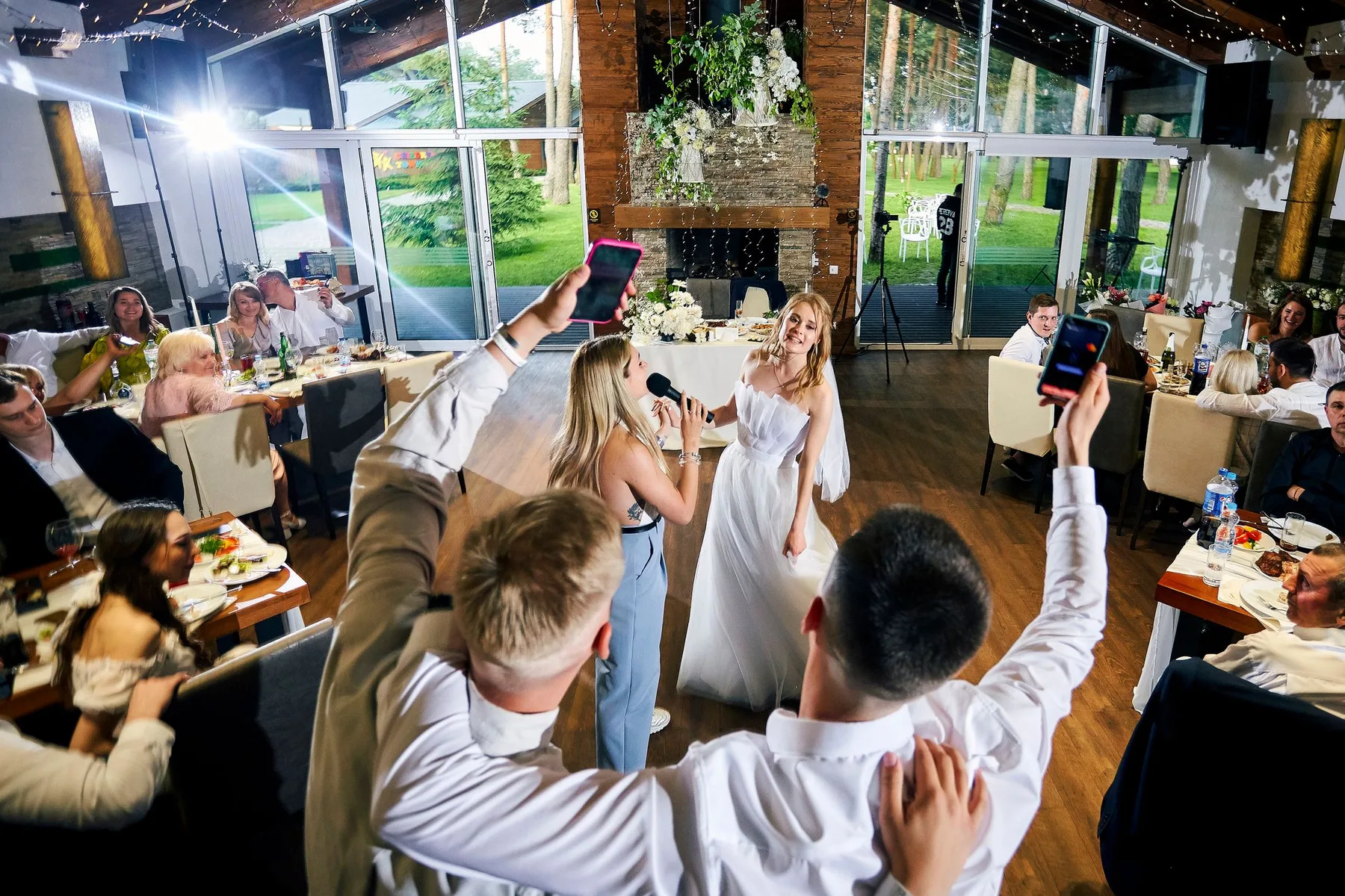 Guests with their arms in the air on a crowded dance floor
