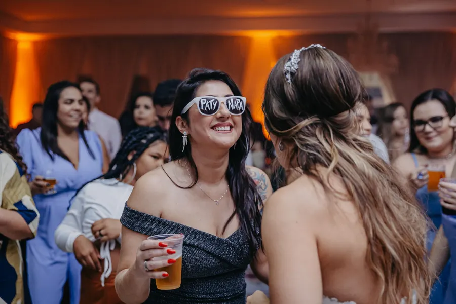 Two guests laughing together in the middle of a party