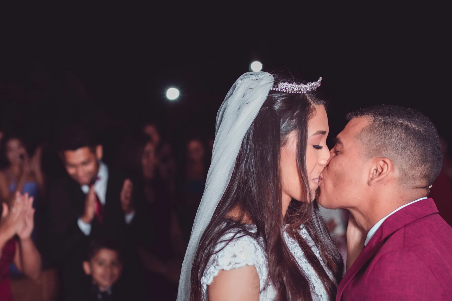 Guests holding sparklers as the couple pass between them