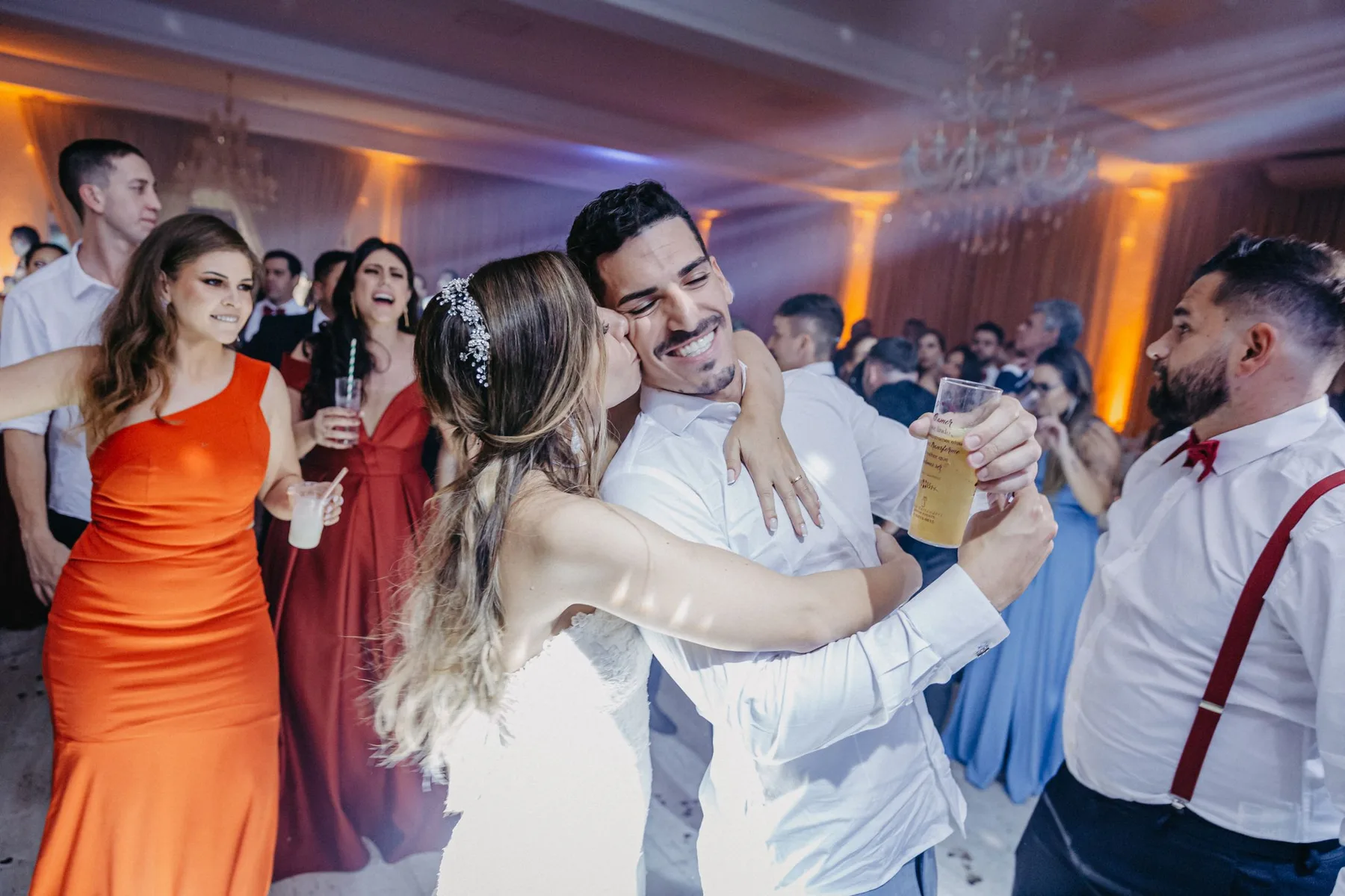 A guest raising a glass in a crowded room